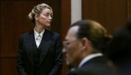 Actors Amber Heard and Johnny Depp wait at the courtroom at the Fairfax County Circuit Courthouse in Fairfax, Virginia, US, May 17, 2022. (Reuters)