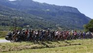 July 12, 2022 Riders wait after the race is neutralized due protestors blocking the route REUTERS/Gonzalo Fuentes