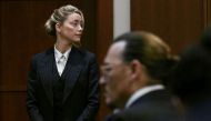 Actors Amber Heard and Johnny Depp wait at the courtroom at the Fairfax County Circuit Courthouse in Fairfax, Virginia, US, May 17, 2022. (REUTERS)