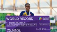 Gold medallist Sydney McLaughlin of the U.S. celebrates on the podium with a cheque during the medal ceremony after winning the women's 400 metres hurdles final and setting a new world record REUTERS/Aleksandra Szmigiel