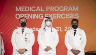 New WCM-Q first-year medical student Mohammed Al Ansari receives his white coat from Dr. Amine Rakab of WCM-Q (left) and Dr. Vijay Jeganath of HMC. 