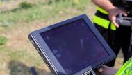 A firefighter looks at the screen as drone flying above Seine river monitors whale's movements at Saint-Pierre-la-Garenne, France, August 4, 2022. (Reuters/Pascal Rossignol/File Photo)