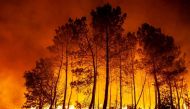 A wildfire burns near Hostens, as wildfires continue to spread in the Gironde region of southwestern France, in this handout photograph released on August 12, 2022. Courtesy SDIS 33/Handout via REUTERS