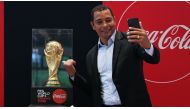 Former Arsenal player and 2002 FIFA World Cup™ winner Gilberto Silva with the FIFA World Cup trophy.