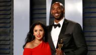 Kobe Bryant holds his Oscar for Best Animated Short, with wife Vanessa. REUTERS/Danny Moloshok/File Photo
