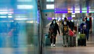 FILE PHOTO: Passengers walk through a terminal at Frankfurt Airport, as the spread of the coronavirus disease (COVID-19) continues in Frankfurt, Germany, April 1, 2021. REUTERS/Ralph Orlowski
