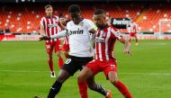 File Photo: Valencia's Yunus Musah in action with Atletico Madrid's Renan Lodi. (REUTERS/Albert Gea)