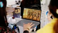 Fans of K-pop idol boy band BTS watch a live streaming online concert at a cafe in Seoul, South Korea October 10, 2020. Reuters/Heo Ran/File Photo