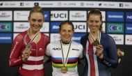 Gold medallist Britain's Neah Evans celebrates on the podium after winning the Women's Points Race of the US Tissot UCI Track World Championships 2022 alongside silver medallist Denmark's Julie Leth and bronze medallist Jennifer Valente at the National Velodrome, Saint-Quentin-En-Yvelines, France, on October 16, 2022.  REUTERS/Matthew Childs