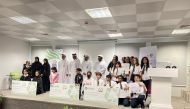 Al Daayen Municipality officials with students of winning schools.