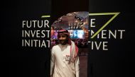 A Saudi man's reflection is seen in mirror glass at the Future Investment Initiative conference, in Riyadh, Saudi Arabia, on October 25, 2022. REUTERS/ Ahmed Yosri