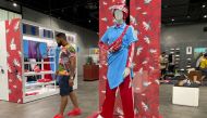 A customer walks past clothing by South African luxury fashion designer, Thebe Magugu, who has showcased his designs in Paris and London, at an Adidas store in Johannesburg, South Africa, October 22, 2022. REUTERS/Taurai Maduna NO RESALES. NO ARCHIVES