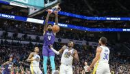 Charlotte Hornets center Nick Richards (4) gets a dunk over Golden State Warriors center Kevon Looney (5) during the second half at Spectrum Center. Jim Dedmon