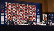 Japan's national football team manager Hajime Moriyasu (centre) speaks as Japan Football Association chairman Kozo Tashima (right) and JFA technical coach Yasuharu Sorimachi listen on during a press conference to officially announce the members of Japan's 2022 World Cup squad headed to Qatar, in Tokyo on November 1, 2022. (Photo by Richard A. Brooks / AFP)