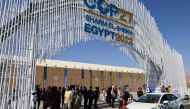 Delegates arrive at the Sharm El Sheikh International Convention Centre, in Egypt's Red Sea resort of the same name, on November 6, 2022, for the 2022 United Nations Climate Change Conference, more commonly known as COP27.  (Photo by JOSEPH EID / AFP)