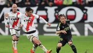 Real Madrid's Croatian midfielder Luka Modric (R) fights for the ball with Rayo Vallecano's Spanish midfielder Santi Comesana during the Spanish league football match between Rayo Vallecano de Madrid and Real Madrid CF at the Vallecas Stadium in the Madrid district of Puente de Vallecas on November 7, 2022. (Photo by Pierre-Philippe Marcou / AFP)