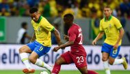 Qatar’s Assim Madebo and Brazil’s Gabriel Jesus (left) vie for the ball during a friendly match in Brasilia, in this June 5, 2019 file photo. AFP