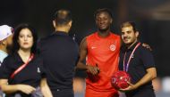 Canada’s Ismael Kone poses for a photograph with a volunteer. Reuters