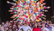 Artist Choi Jeong Hwa with children in front of the artwork ‘Come Together’ in Education City. 