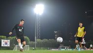 South Korea’s defender Kim Tae-hwan (left) takes part in a training session at Al Egla Training Site 5, yesterday. AFP