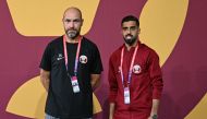 Qatar's Spanish coach Felix Sanchez (left) and Qatar's forward Hassan Al-Haydos arrive for a press conference at the Aspire training site in Doha on November 19, 2022 on the eve of the Qatar 2022 World Cup football opening match between Qatar and Ecuador. (Photo by Raul ARBOLEDA / AFP)