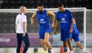 France's forward Karim Benzema (center) and France's defender Raphael Varane takes part in a training session next to France's head coach Guy Stephan (left) at the Jassim-bin-Hamad Stadium in Doha on November 19, 2022, ahead of the Qatar 2022 World Cup football tournament. (Photo by FRANCK FIFE / AFP)