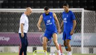 France's forward Karim Benzema (centre) and France's defender Raphael Varane takes part in a training session next to France's head coach Guy Stephan (left) at the Jassim-bin-Hamad Stadium in Doha on November 19, 2022, ahead of the Qatar 2022 World Cup football tournament. (Photo by FRANCK FIFE / AFP)
 