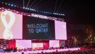 Supporters watch fireworks on a giant screen during the FIFA Fan Festival opening day at Al Bidda park in Doha on November 19, 2022, ahead of the Qatar 2022 World Cup football tournament. (Photo by Kirill Kudryavtsev / AFP)