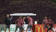 Coach Felix Sanchez watches Qatar players take part in a training session at Aspire Training Site, yesterday.