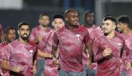 From left: Qatar’s Hassan Al Haydos, Abdelkarim Hassan and Bassam Al Rawi take part in a training session at the Aspire training site, yesterday. Pictures: AFP