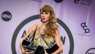 US singer Taylor Swift poses with her six trophies during the 50th Annual American Music Awards. Photo by Valerie Macon / AFP