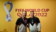 Germany's head coach Hans-Dieter Flick (left) and Germany's midfielder Joshua Kimmich pose on the green carpet ahead of a press conference at the Qatar National Convention Center (QNCC) in Doha on November 22, 2022, on the eve of the Qatar 2022 World Cup football tournament Group E match between Germany and Japan. (Photo by INA FASSBENDER / AFP)