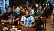 Football fans of Argentina watch the Qatar 2022 World Cup Group C football match between Argentina and Saudi Arabia on November 22, 2022 in Buenos Aires. - Saudi Arabia stunned Lionel Messi's Argentina, beating the two-time winners 2-1 in one of the biggest upsets in World Cup history. (Photo by Luis ROBAYO / AFP)