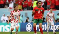 Croatia's midfielder #10 Luka Modric follows Morocco's midfielder #11 Abdelhamid Sabiri during the Qatar 2022 World Cup Group F football match between Morocco and Croatia at the Al-Bayt Stadium in Al Khor, north of Doha on November 23, 2022. (Photo by OZAN KOSE / AFP)
 