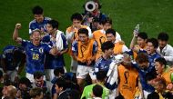 Japan's players celebrate their win in the Qatar 2022 World Cup Group E football match between Germany and Japan at the Khalifa International Stadium in Doha on November 23, 2022. (Photo by Anne-Christine POUJOULAT / AFP)