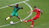 Switzerland's Granit Xhaka in action with Cameroon's Nicolas Nkoulou during the Qatar 2022 World Cup Group G football match between Switzerland and Cameroon at the Al-Janoub Stadium in Al-Wakrah, south of Doha on November 24, 2022. (Photo by Glyn KIRK / AFP) 