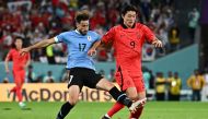 Uruguay's defender Matias Vina fights for the ball with South Korea's forward Cho Gue-sung during the Qatar 2022 World Cup Group H football match between Uruguay and South Korea at the Education City Stadium in Al-Rayyan, west of Doha on November 24, 2022. (Photo by Anne-Christine POUJOULAT / AFP)