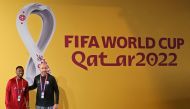 Qatar's Spanish coach Felix Sanchez (right) and Qatar's defender Ismaiel Mohammed pose for a photograph ahead of a press conference at the Qatar National Convention Center (QNCC) in Doha on November 24, 2022, on the eve of the Qatar 2022 World Cup football match between Qatar and Senegal. (Photo by KARIM JAAFAR / AFP)