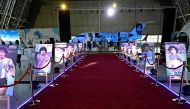 A general view of posters of Argentina's Diego Maradona on the second anniversary of his death at a fan zone devoted to the Argentine at Doha's international airport on November 25, 2022. (Photo by JAVIER SORIANO / AFP)