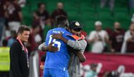 Senegal's coach Aliou Cisse and goalkeeper Edouard Mendy embrace after the final whistle of the Qatar 2022 World Cup Group A football match between Qatar and Senegal at the Al Thumama Stadium on November 25, 2022. (Photo by OZAN KOSE / AFP)