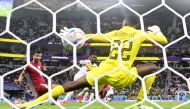 Senegal's Bamba Dieng scores his team's third goal during the Qatar 2022 World Cup Group A football match between Qatar and Senegal at the Al Thumama Stadium on November 25, 2022. (Photo by Odd Andersen / AFP)