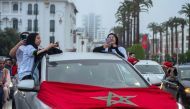 Moroccan football fans celebrate in Rabat after their country's win of the Qatar 2022 World Cup Group F football match between Belgium and Morocco, on November 27, 2022. (Photo by JALAL MORCHIDI / AFP)