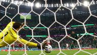 Poland’s Wojciech Szczesny saves a penalty from Saudi Arabia’s Salem Al Dawsari.