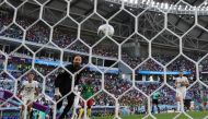 Cameroon's forward #10 Vincent Aboubakar (C) scores his team's second goal past Serbia's goalkeeper #23 Vanja Milinkovic-Savic (2nd L) . (Photo by Adrian Dennis / AFP)