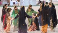 Children playing a traditional game at Darb Al Saai.