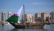 A traditional Qatari Dhow boat bearing Wales' sail is pictured in Doha on November 29, 2022, during the Qatar 2022 World Cup football tournament. (Photo by NATALIA KOLESNIKOVA / AFP)