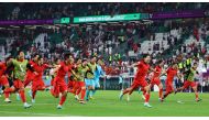 South Korea players celebrate after the match as South Korea qualify for the knockout stages during the Qatar World Cup final Group H match between Korea and Portugal at the Education City Stadium on December 2, 2022. (REUTERS/Wolfgang Rattay)