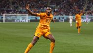 Netherlands' defender #22 Denzel Dumfries celebrates scoring his team's third goal during the Qatar 2022 World Cup round of 16 football match between the Netherlands and USA at Khalifa International Stadium in Doha on December 3, 2022. (Photo by ADRIAN DENNIS / AFP)