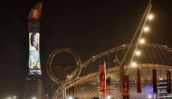 A picture taken on December 3, 2022, in Doha, during the Qatar 2022 World Cup football tournament, shows the Torch tower of Doha also known as the Aspire Tower, lit by a screen depicting Brazilian star Pele and reading a message in support to the former Brazilian football player who is being treated for a 