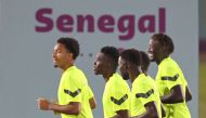 From left: Senegal’s defender Abdou Diallo, forward Ismaila Sarr, midfielder Moustapha Name and forward Famara Diedhiou attend a training session at Al Duhail SC, yesterday.  AFP